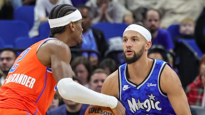 Feb 13, 2024; Orlando, Florida, USA; Orlando Magic guard Jalen Suggs (4) defends Oklahoma City Thunder guard Shai Gilgeous-Alexander (2) during the first quarter at Amway Center. Mandatory Credit: Mike Watters-Imagn Images