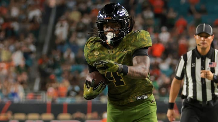 Oct 25, 2025; Miami Gardens, Florida, USA; Miami Hurricanes running back Mark Fletcher Jr. (4) carries the football against Stanford Cardinal safety Mitch Leigber (32) during the third quarter at Hard Rock Stadium. Mandatory Credit: Sam Navarro-Imagn Images