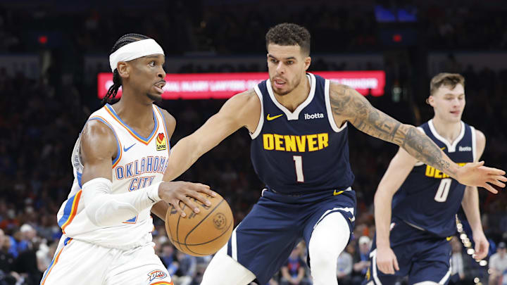Mar 10, 2025; Oklahoma City, Oklahoma, USA; Oklahoma City Thunder guard Shai Gilgeous-Alexander (2) drives to the basket as Denver Nuggets forward Michael Porter Jr. (1) defends during the second half at Paycom Center. Mandatory Credit: Alonzo Adams-Imagn Images Mar 10, 2025; Oklahoma City, Oklahoma, USA; Oklahoma City Thunder guard Shai Gilgeous-Alexander (2) drives to the basket as Denver Nuggets forward Michael Porter Jr. (1) defends during the second half at Paycom Center. Mandatory Credit: Alonzo Adams-Imagn Images