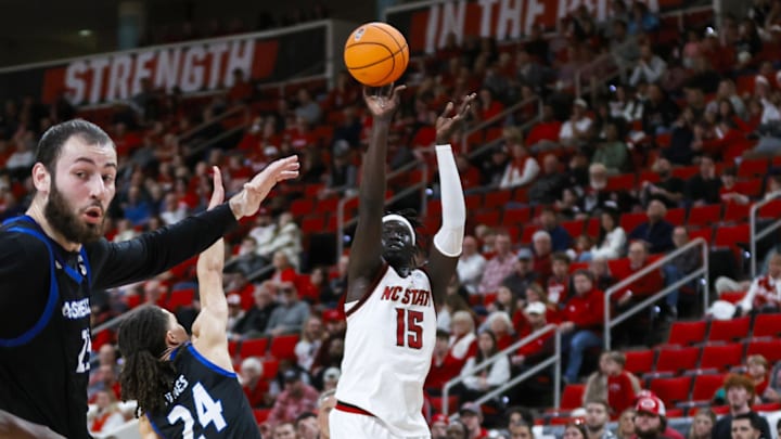 Dec 6, 2025; Raleigh, North Carolina, USA; NC State Wolfpack forward Jerry Deng (15) shoots a 3-pointer past UNC Asheville Bulldogs guard Corey Jones (24) during the first half of the game at Lenovo Center. Mandatory Credit: Jaylynn Nash-Imagn Images Dec 6, 2025; Raleigh, North Carolina, USA; NC State Wolfpack forward Jerry Deng (15) shoots a 3-pointer past UNC Asheville Bulldogs guard Corey Jones (24) during the first half of the game at Lenovo Center. Mandatory Credit: Jaylynn Nash-Imagn Images