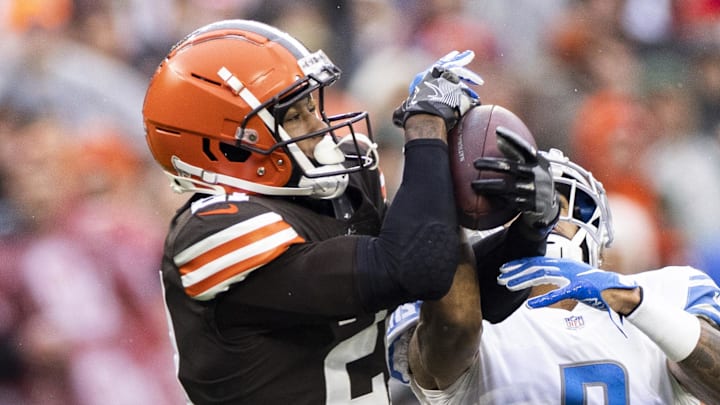 Nov 21, 2021; Cleveland, Ohio, USA; Cleveland Browns cornerback Denzel Ward (21) intercepts the ball from Detroit Lions wide receiver Josh Reynolds (8) during the third quarter at FirstEnergy Stadium. Mandatory Credit: Scott Galvin-Imagn Images Nov 21, 2021; Cleveland, Ohio, USA; Cleveland Browns cornerback Denzel Ward (21) intercepts the ball from Detroit Lions wide receiver Josh Reynolds (8) during the third quarter at FirstEnergy Stadium. Mandatory Credit: Scott Galvin-Imagn Images