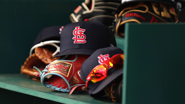Apr 24, 2022; Cincinnati, Ohio, USA; A view of St. Louis Cardinals players    hats and gloves in the dugout during a game with the Cincinnati Reds at Great American Ball Park. Mandatory Credit: David Kohl-Imagn Images
