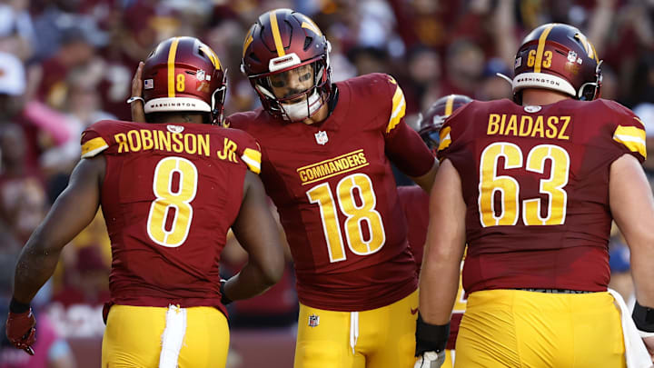 Oct 20, 2024; Landover, Maryland, USA; Washington Commanders running back Brian Robinson Jr. (8) celebrates with Commanders quarterback Marcus Mariota (18) after scoring a touchdown against the Carolina Panthers during the second quarter at Northwest Stadium. Mandatory Credit: Geoff Burke-Imagn Images Oct 20, 2024; Landover, Maryland, USA; Washington Commanders running back Brian Robinson Jr. (8) celebrates with Commanders quarterback Marcus Mariota (18) after scoring a touchdown against the Carolina Panthers during the second quarter at Northwest Stadium. Mandatory Credit: Geoff Burke-Imagn Images