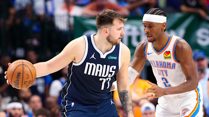 May 11, 2024; Dallas, Texas, USA; Dallas Mavericks guard Luka Doncic (77) controls the ball as Oklahoma City Thunder guard Shai Gilgeous-Alexander (2) defends during the second half during game three of the second round for the 2024 NBA playoffs at American Airlines Center. Mandatory Credit: Kevin Jairaj-Imagn Images