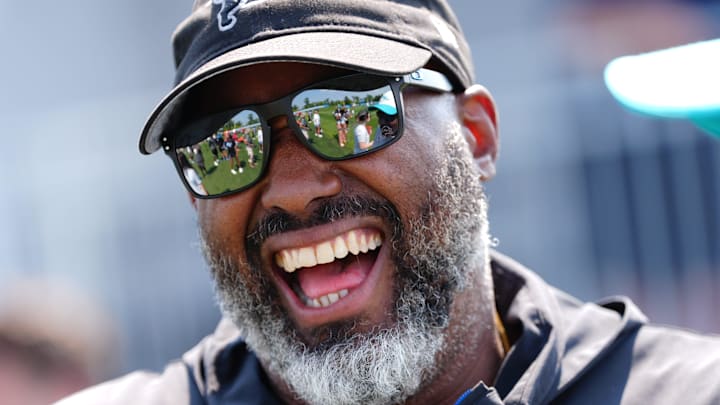 Detroit Lions Executive Vice President and General Manager Brad Holmes laughs with Miami Dolphins coaches