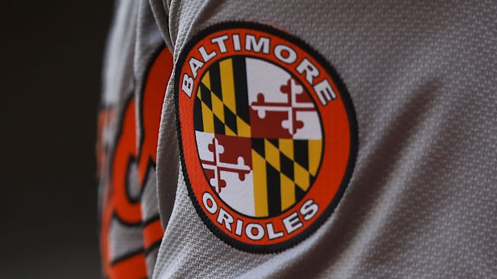 May 5, 2024; Cincinnati, Ohio, USA; The Baltimore Orioles logo on the sleeve of designated hitter Gunnar Henderson (2) as he prepares on deck during the seventh inning against the Cincinnati Reds at Great American Ball Park. May 5, 2024; Cincinnati, Ohio, USA; The Baltimore Orioles logo on the sleeve of designated hitter Gunnar Henderson (2) as he prepares on deck during the seventh inning against the Cincinnati Reds at Great American Ball Park.