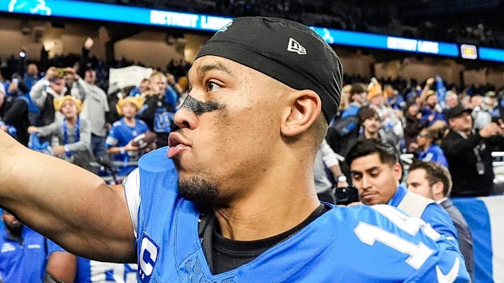 Detroit Lions wide receiver Amon-Ra St. Brown (14) waves a turkey leg at fans to celebrate 23-20 win over Chicago Bears at Ford Field in Detroit on Thursday, Nov. 28, 2024.