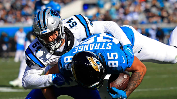 Carolina Panthers linebacker Kamu Grugier-Hill tackles Jacksonville Jaguars tight end Brenton Strange.