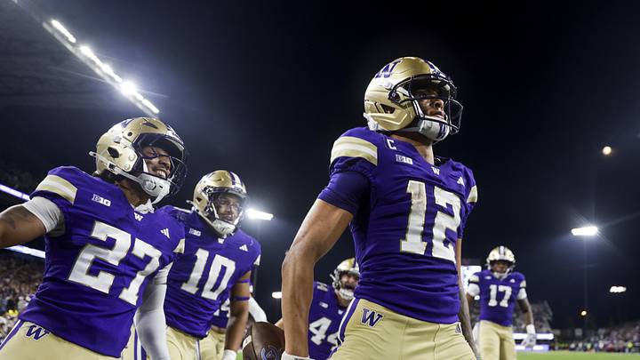 Sep 6, 2025; Seattle, Washington, USA; Washington Huskies wide receiver Denzel Boston (12) celebrates after returning a punt for a touchdown against the UC Davis Aggies during the second quarter at Husky Stadium. Washington Huskies safety Vincent Holmes (27) and linebacker Xe'ree Alexander (10) follow behind Boston. Mandatory Credit: Joe Nicholson-Imagn Images