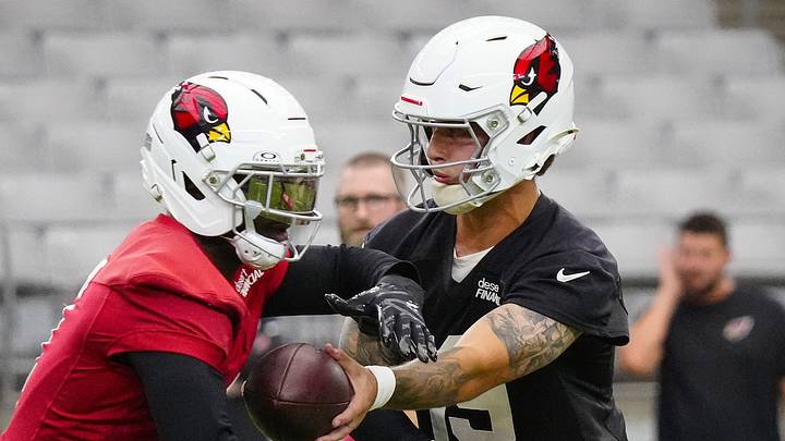Cardinals quarterback Carson Beck (19) hands the ball off to running back Jeremiyah Love (4) during training camp at State Farm Stadium in Glendale on July 23, 2026.