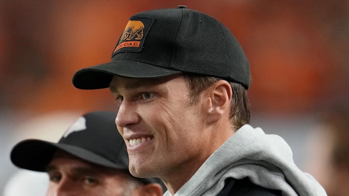 Jan 19, 2026; Miami Gardens, FL, USA; Tom Brady looks on from the sideline before the CFP National Championship college football game between the Indiana Hoosiers and the Miami Hurricanes at Hard Rock Stadium. Mandatory Credit: Kirby Lee-Imagn Images