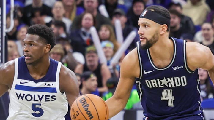 Jan 9, 2024; Orlando, Florida, USA; Orlando Magic guard Jalen Suggs (4) brings the ball up court against Minnesota Timberwolves guard Anthony Edwards (5) during the second half at KIA Center. Mandatory Credit: Mike Watters-Imagn Images