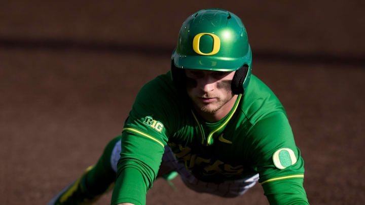 Oregon infielder Ryan Cooney dives safely back to first base as the Oregon Ducks host the Youngstown State Penguins on Feb. 19, 2026, at PK Park in Eugene, Oregon.