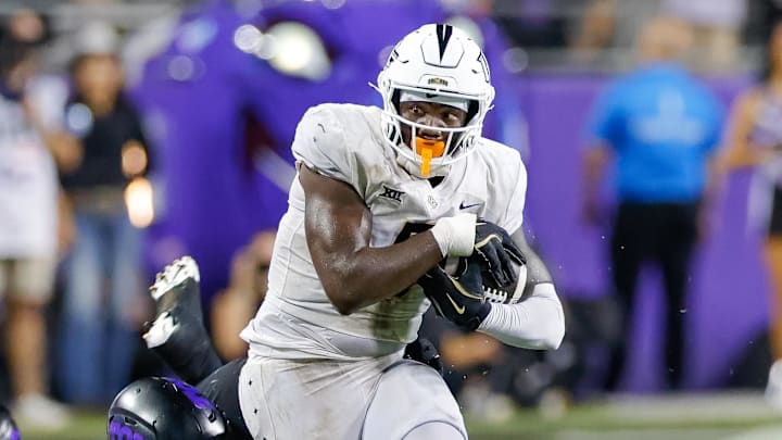 Sep 14, 2024; Fort Worth, Texas, USA; TCU Horned Frogs defensive lineman Caleb Fox (90) attempts a tackle on UCF Knights tight end Randy Pittman Jr. (5) during the fourth quarter at Amon G. Carter Stadium. Mandatory Credit: Andrew Dieb-Imagn Images