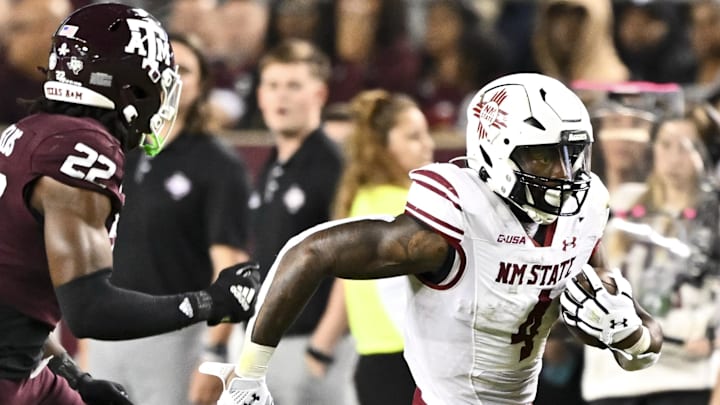 New Mexico State Aggies running back Mike Washington (4) runs the ball during the second half as Texas A&M Aggies linebacker Solomon DeShields (22) defends at Kyle Field. Mandatory Credit: New Mexico State Aggies running back Mike Washington (4) runs the ball during the second half as Texas A&M Aggies linebacker Solomon DeShields (22) defends at Kyle Field. Mandatory Credit: