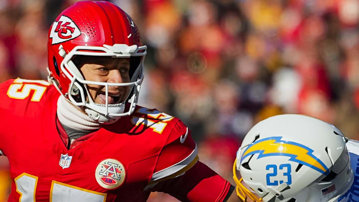 Dec 14, 2025; Kansas City, Missouri, USA; Kansas City Chiefs quarterback Patrick Mahomes (15) scrambles against Los Angeles Chargers safety Tony Jefferson (23) during the first half at GEHA Field at Arrowhead Stadium. Mandatory Credit: Jay Biggerstaff-Imagn Images