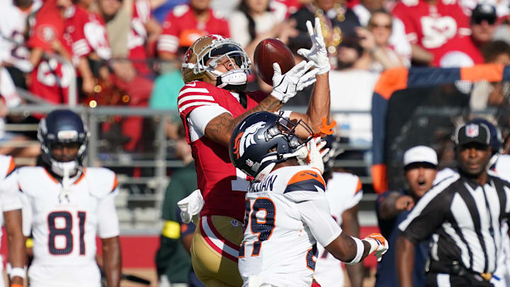 San Francisco 49ers wide receiver Jordan Watkins makes a reception over Denver Broncos cornerback Ja'Quan McMillian (29) San Francisco 49ers wide receiver Jordan Watkins makes a reception over Denver Broncos cornerback Ja'Quan McMillian (29)