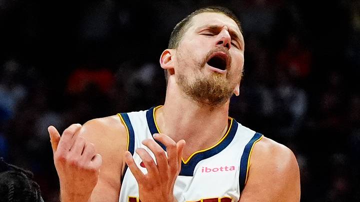 Oct 11, 2026; Denver, Colorado, USA;  Chicago Bulls guard Buddy Hield (7) collides into Denver Nuggets center Nikola Jokic (15) in the second quarter at Ball Arena.  Mandatory Credit: Ron Chenoy-Imagn Images