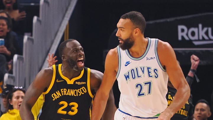 Nov 12, 2023; San Francisco, California, USA; Golden State Warriors forward Draymond Green (23) celebrates behind Minnesota Timberwolves center Rudy Gobert (27) after scoring a three point basket during the first quarter at Chase Center. Nov 12, 2023; San Francisco, California, USA; Golden State Warriors forward Draymond Green (23) celebrates behind Minnesota Timberwolves center Rudy Gobert (27) after scoring a three point basket during the first quarter at Chase Center.