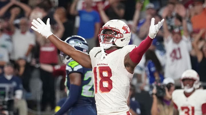 Arizona Cardinals receiver Marvin Harrison Jr. (18) celebrates a touchdown by teammate Emari Demercado (31) to tie the game at 20-20 against the Seattle Seahawks at State Farm Stadium in Glendale on Sept. 25, 2025.
