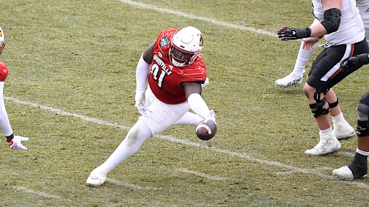 Dec 17, 2022; Boston, MA, USA; Louisville Cardinals defensive lineman Tawfiq Thomas (91) reaches out