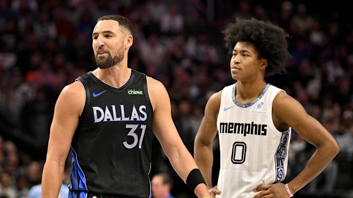 Nov 22, 2025; Dallas, Texas, USA; Dallas Mavericks guard Klay Thompson (31) and Memphis Grizzlies forward Jaylen Wells (0) look on during the game between the Mavericks and the Grizzlies at American Airlines Center. Mandatory Credit: Jerome Miron-Imagn Images