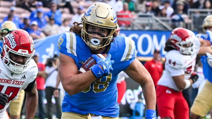 Nov 30, 2024; Pasadena, California, USA; UCLA Bruins tight end Moliki Matavao (88) Fresno State Bulldogs defensive back Jakari Embry (17) during the first quarter at Rose Bowl. Mandatory Credit: Robert Hanashiro-Imagn Images
