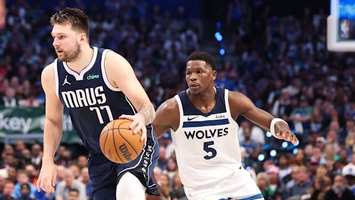 May 28, 2024; Dallas, Texas, USA; Dallas Mavericks guard Luka Doncic (77) dribbles as Minnesota Timberwolves guard Anthony Edwards (5) defends during the third quarter of game four of the western conference finals for the 2024 NBA playoffs at American Airlines Center. Mandatory Credit: Kevin Jairaj-Imagn Images