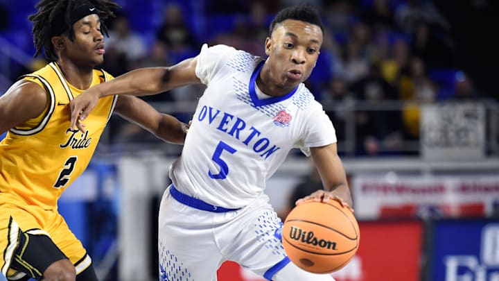 Memphis Overton's Jordan Frison (5) dribbles past McMinn County's Davion Evans (2) during the 2023 Class 4A TSSAA BlueCross Boys Basketball quarterfinals at Murphy Center Complex in Murfreesboro, Tenn. on Tuesday, March 14, 2023.