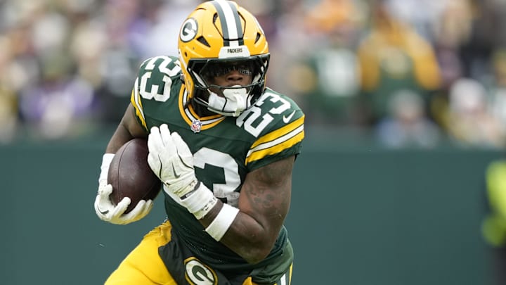 Nov 23, 2025; Green Bay, Wisconsin, USA; Green Bay Packers running back Emanuel Wilson (23) carries the ball against the Minnesota Vikings during the first half at Lambeau Field. Mandatory Credit: Kayla Wolf-Imagn Images