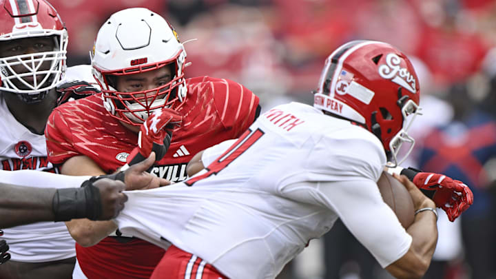 Aug 31, 2024; Louisville, Kentucky, USA;  Louisville Cardinals defensive lineman Thor Griffith (50) sacks Austin Peay Governors quarterback Austin Smith (4) during the second half at L&N Federal Credit Union Stadium. Louisville defeated Austin Peay 62-0. Mandatory Credit: Jamie Rhodes-Imagn Images