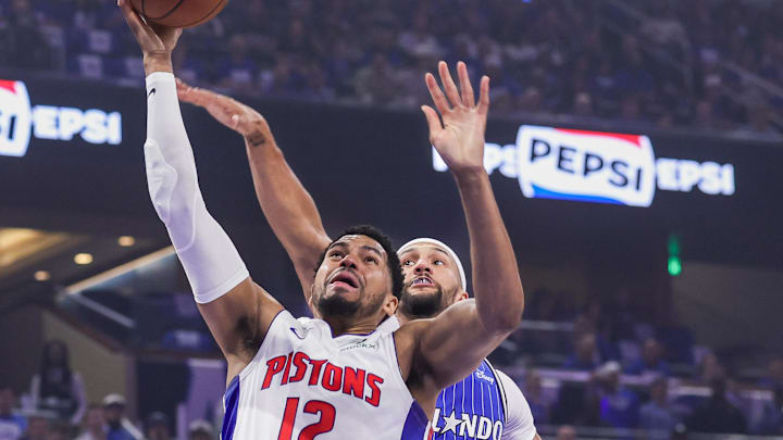 Apr 27, 2026; Orlando, Florida, USA; Detroit Pistons forward Tobias Harris (12) goes to the basket against Orlando Magic guard Jalen Suggs (4) during the first quarter during game four of the first round of the 2026 NBA Playoffs at Kia Center. Mandatory Credit: Mike Watters-Imagn Images