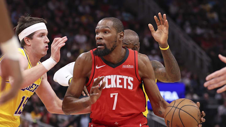 Mar 16, 2026; Houston, Texas, USA; Houston Rockets forward Kevin Durant (7) dribbles the ball as Los Angeles Lakers guard Austin Reaves (15) defends during the first quarter at Toyota Center. Mandatory Credit: Troy Taormina-Imagn Images