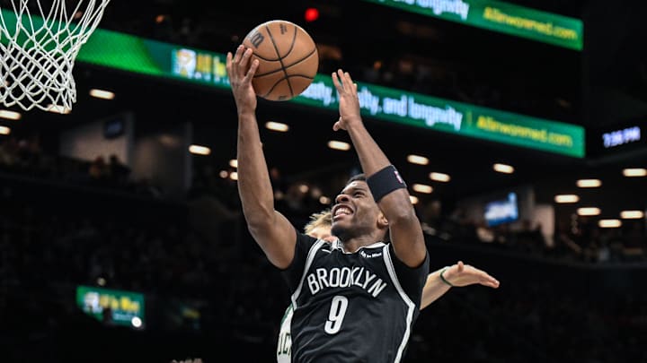 Apr 7, 2026; Brooklyn, New York, USA; Brooklyn Nets forward E.J. Liddell (9) drives past Milwaukee Bucks guard AJ Green (20) during the first half at Barclays Center. Mandatory Credit: John Jones-Imagn Images