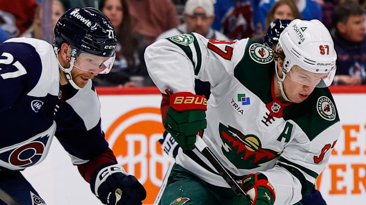 Mar 8, 2026; Denver, Colorado, USA; Minnesota Wild left wing Kirill Kaprizov (97) controls the puck under pressure from Colorado Avalanche center Brett Kulak (27) in the third period at Ball Arena. Mandatory Credit: Isaiah J. Downing-Imagn Images