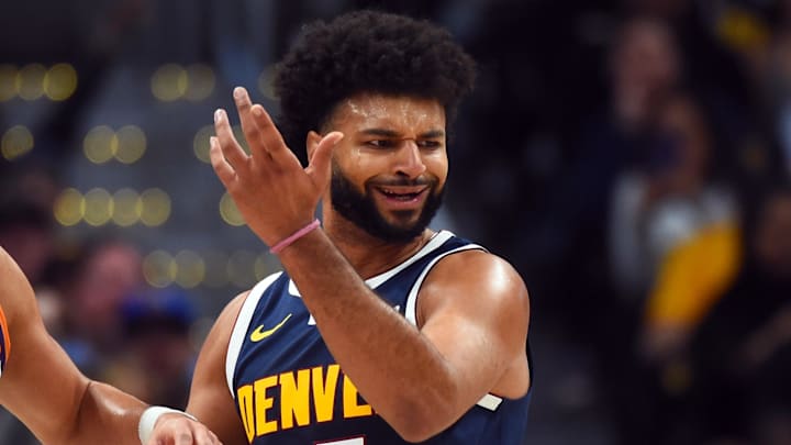 Oct 25, 2025; Denver, Colorado, USA; Denver Nuggets guard Jamal Murray (27) reacts after a play against Phoenix Suns guard Devin Booker (1) during the first half at Ball Arena. Mandatory Credit: Christopher Hanewinckel-Imagn Images