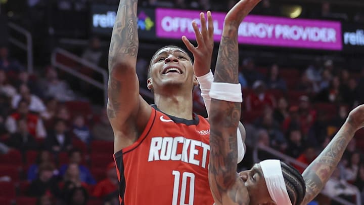 Feb 21, 2025; Houston, Texas, USA; Houston Rockets forward Jabari Smith Jr. (10) shoots the ball as Minnesota Timberwolves guard Nickeil Alexander-Walker (9) defends during the fourth quarter at Toyota Center. Mandatory Credit: Troy Taormina-Imagn Images