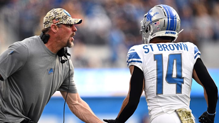 Nov 12, 2023; Inglewood, California, USA; Detroit Lions head coach Dan Campbell (left) congratulates wide receiver Amon-Ra St. Brown (14) after a Lions touchdown  against the Los Angeles Chargers during the first half at SoFi Stadium. Mandatory Credit: Orlando Ramirez-Imagn Images
