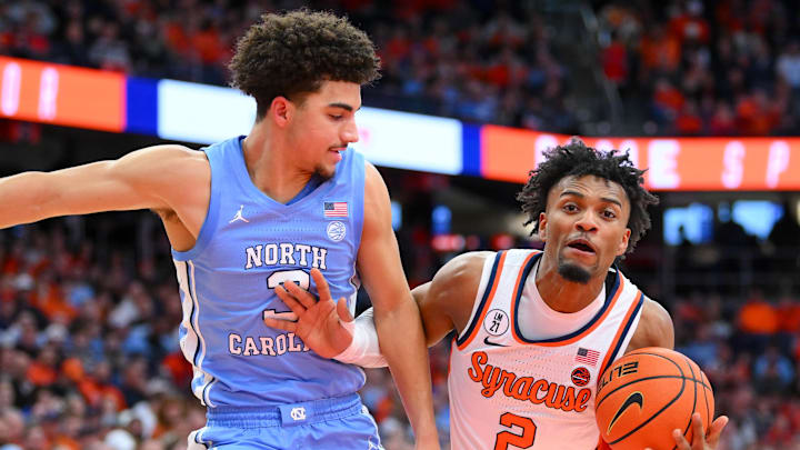Feb 21, 2026; Syracuse, New York, USA; Syracuse Orange guard J.J. Starling (2) drives against North Carolina Tar Heels guard Derek Dixon (3) during the second half at the JMA Wireless Dome. Mandatory Credit: Rich Barnes-Imagn Images