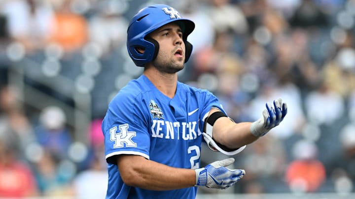 Jun 19, 2024; Omaha, NE, USA;  Kentucky Wildcats left fielder Ryan Waldschmidt (21) takes first base on a walk to start the game against the Florida Gators during the first inning at Charles Schwab Field Omaha. Mandatory Credit: Steven Branscombe-Imagn Images