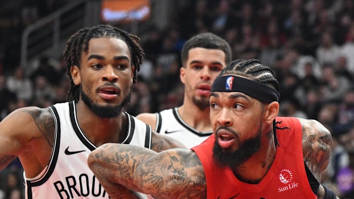 Toronto Raptors forward Brandon Ingram dribbles the ball past Brooklyn Nets center Nic Claxton.