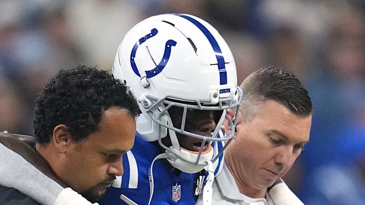 Sauce Gardner of the Indianapolis Colts limps off the field