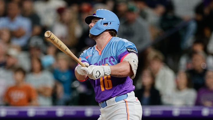 Colorado Rockies first baseman Blaine Crim (16) watches his ball on a sacrifice fly RBI in the fifth inning against the Los Angeles Angels at Coors Field. 
