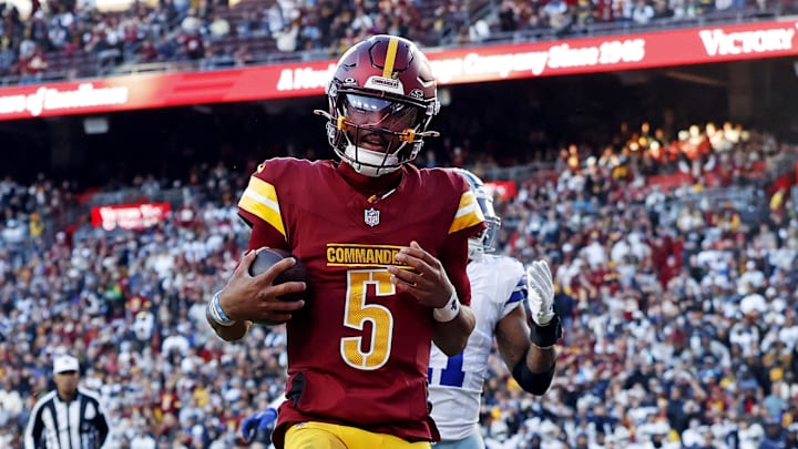 Nov 24, 2024; Landover, Maryland, USA; Washington Commanders quarterback Jayden Daniels (5) scores a two point conversion during the fourth quarter against the Dallas Cowboys at Northwest Stadium. Mandatory Credit: Peter Casey-Imagn Images Nov 24, 2024; Landover, Maryland, USA; Washington Commanders quarterback Jayden Daniels (5) scores a two point conversion during the fourth quarter against the Dallas Cowboys at Northwest Stadium. Mandatory Credit: Peter Casey-Imagn Images