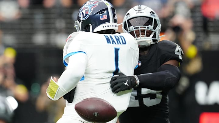 Oct 12, 2025; Paradise, Nevada, USA; Las Vegas Raiders linebacker Devin White (45) sacks Tennessee Titans quarterback Cam Ward (1) during the second half at Allegiant Stadium. Mandatory Credit: Stephen R. Sylvanie-Imagn Images