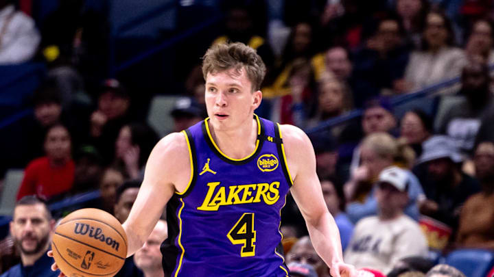 Nov 16, 2024; New Orleans, Louisiana, USA; Los Angeles Lakers guard Dalton Knecht (4) brings the ball up court against the New Orleans Pelicans during the first half at Smoothie King Center. Mandatory Credit: Stephen Lew-Imagn Images