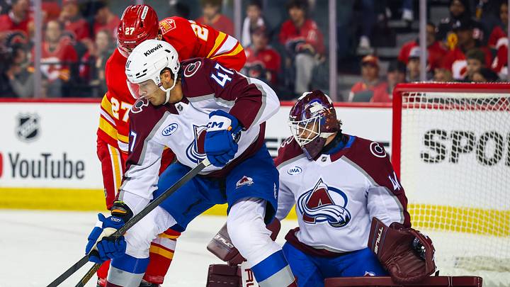 Oct 8, 2026; Calgary, Alberta, CAN; Colorado Avalanche defenseman Noah Juulsen (47) and Calgary Flames right wing Matt Coronato (27) battle for the puck in front of Colorado Avalanche goaltender Scott Wedgewood (41) during the first period at Scotiabank Saddledome. Mandatory Credit: Sergei Belski-Imagn Images