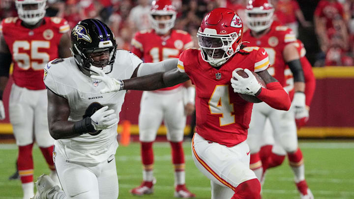 Sep 5, 2024; Kansas City, Missouri, USA; Kansas City Chiefs wide receiver Rashee Rice (4) runs the ball as Baltimore Ravens linebacker Roquan Smith (0) attempts the tackle during the game at GEHA Field at Arrowhead Stadium. Mandatory Credit: Denny Medley-Imagn Images