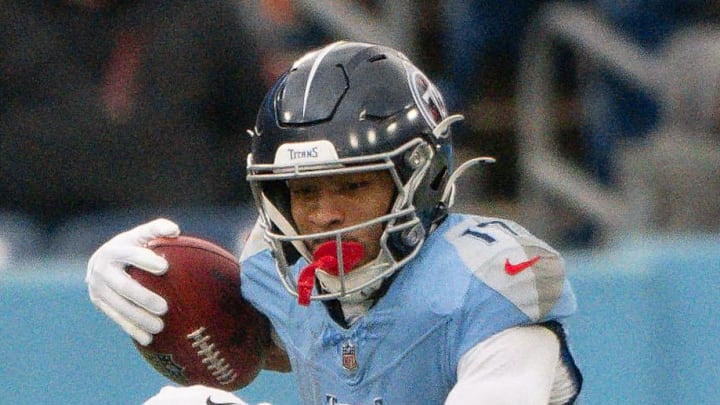Los Angeles Chargers linebacker Daiyan Henley tackles Tennessee Titans wide receiver Chimere Dike.