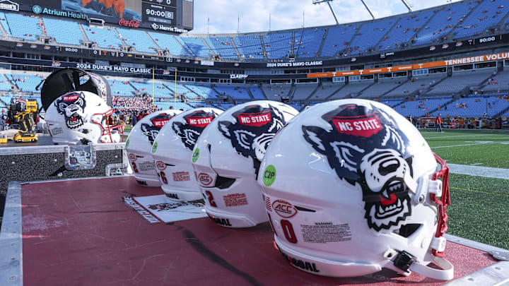 Sep 7, 2024; Charlotte, North Carolina, USA; North Carolina State Wolfpack helmets during pregame activity for the Dukes Mayo Classic against the Tennessee Volunteers at Bank of America Stadium. Mandatory Credit: Jim Dedmon-Imagn Images